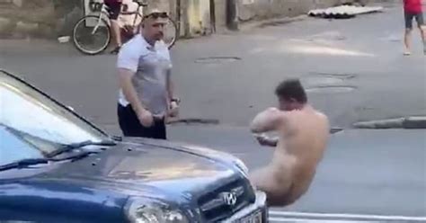 Watch Naked Man Blocking Traffic Gets Knocked Out By Punch