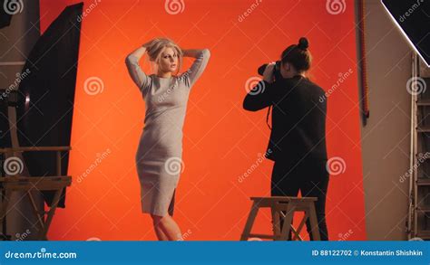 Fashion Backstage Blonde Girl Model And Photographer Photo Session In Studio Stock Photo