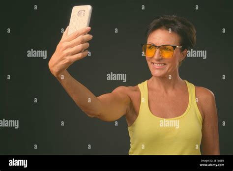 Mature Beautiful Woman With Short Hair Against Black Background Stock Photo Alamy