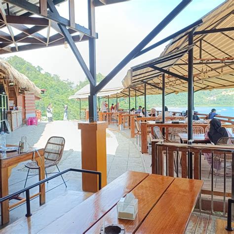 Wooden Tables and Chairs in a Restaurant on the Beach at Puncak Mandeh, Indonesia Editorial ...