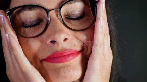 Portrait Of A Brunette Woman With Red Lips Who Eroticly And Playfully Tries On Different Pairs