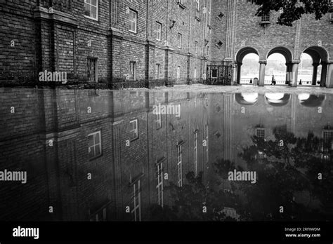 A Wet Courtyard To Large Brick Building Stock Photo Alamy