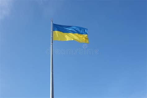 Ukrainian Flag Isolated On The Blue Sky With Clipping Path Close Up