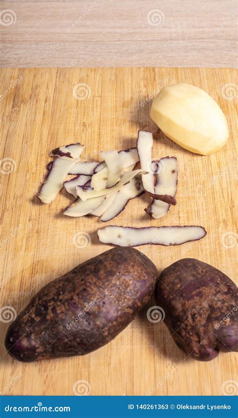 Peeling Potatoes on a Wooden Table Stock Image - Image of board, fresh ...