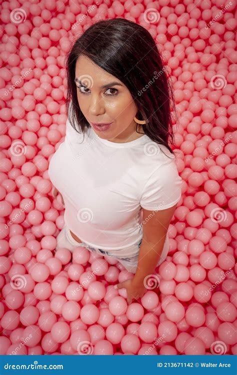 A Lovely Brunette Model Plays In A Room Full Of Plastic Balls Stock Photo Image Of Girl Asian