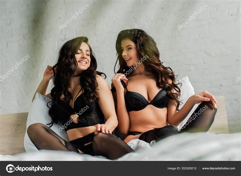 Smiling Sexy Women Black Lingerie Hugging Bed Stock Photo