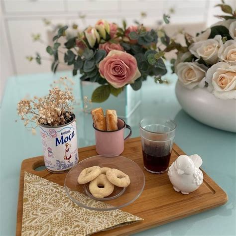 There Is A Tray With Donuts And Drinks On The Table Next To Some Flowers