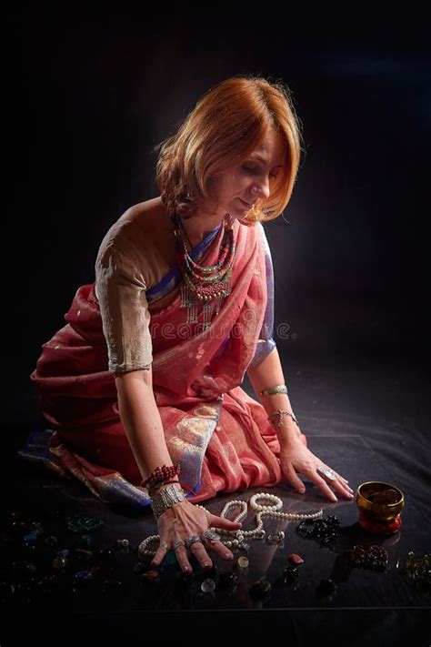 An Adult Skinny Blonde Woman Doing Yoga Exercises On A Black Background In The Studio Sporty