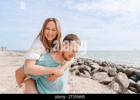 Nude Man Giving Nude Woman Piggyback Into Water Stock Photo Alamy
