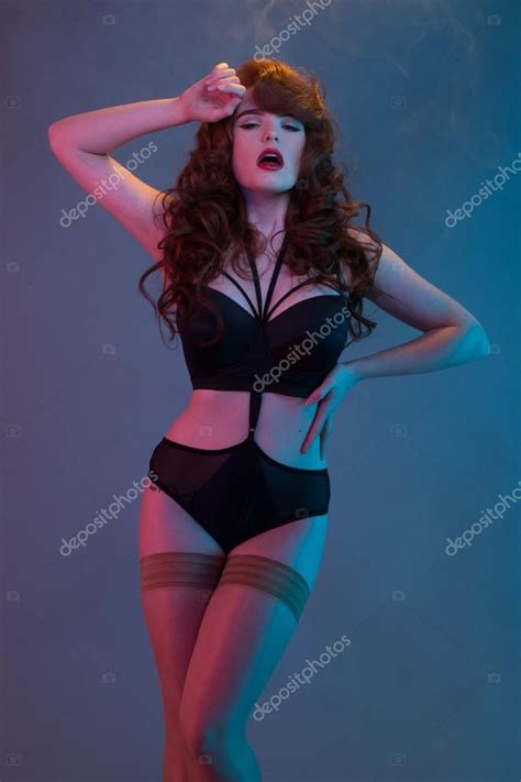 Red Haired Woman Wearing Lingerie And Stockings Stock Photo By Nelka