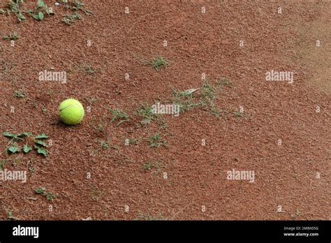 Tennis Ball In Red Clay Tennis Court Stock Photo Alamy