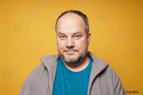 Casual Chubby Mature Man Against Yellow Background Stock Photo Crushpixel