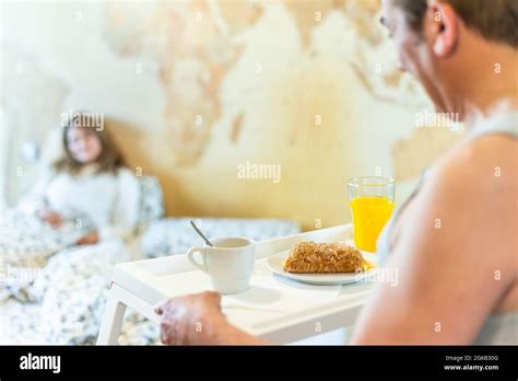 Mature Man In Love Bringing His Wife Breakfast In Bed On A Tray Stock Photo Alamy
