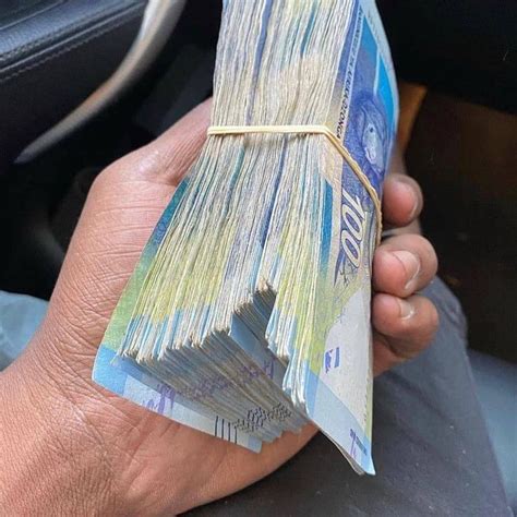 A Person Is Holding Money In Their Hand