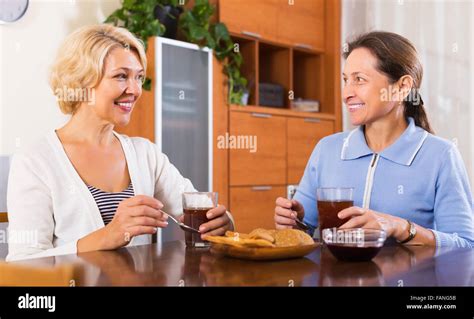 Happy Mature Women Having Tea Break At Office Focus On Blonde Woman Stock Photo Alamy