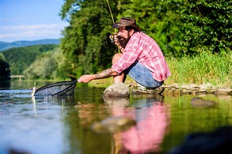 Premium Photo Successful Fisherman In Lake Water Big Game Fishing