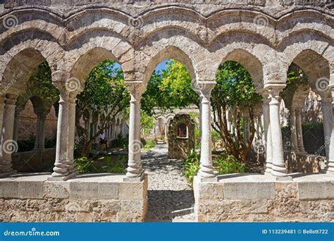 Some Tourists Visit The Cloister Of The Monastery Of San Giovanni Degli