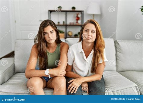 Mother And Daughter Together Sitting On The Sofa At Home Relaxed With