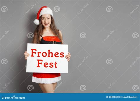Frohes Fest Female Santa Wishes Happy Holidays In German Stock Photo
