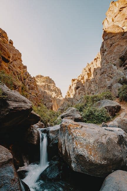 Waterfall Flowing In Rocky Ravine · Free Stock Photo