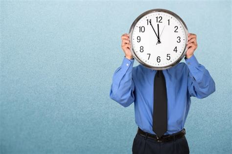 Premium Photo Businessman Holding Clock