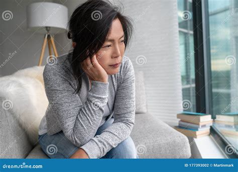 Sad Asian Mature Woman Lonely At Home Self Isolation Quarantine For COVID Coronavirus Social
