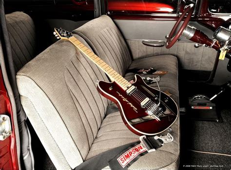 An Electric Guitar Sitting On The Back Seat Of A Car