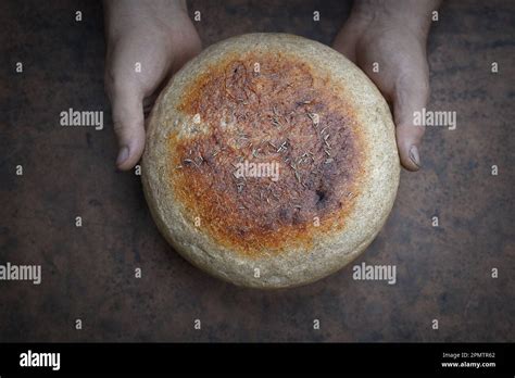 homemade crusty loave  bread  wooden background baker holding