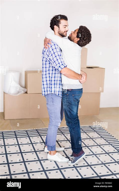 Happy Gay Couple Hugging In New House Stock Photo Alamy