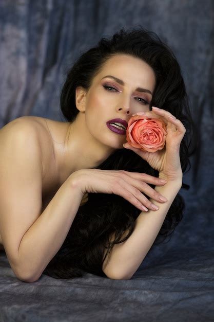 Premium Photo Beauty Shoot Of Wonderful Naked Brunette Model With Rose In Mouth Posing At Studio