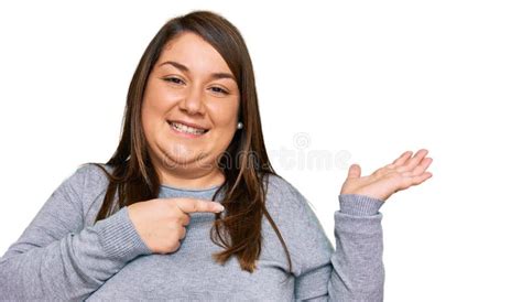 Beautiful Brunette Plus Size Woman Wearing Casual Clothes Amazed And Smiling To The Camera While