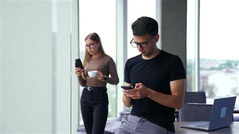 Young Office Workers Using Phones During Lunch Break People Stock