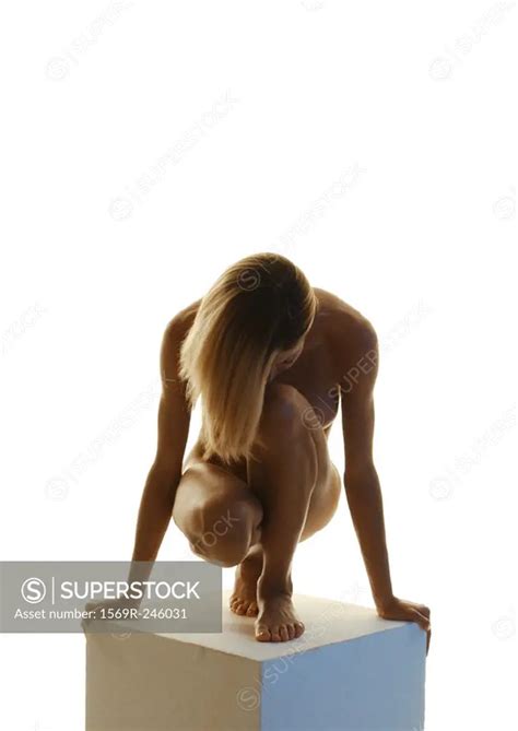 Nude Woman With Head Down Crouching On Pedestal Front View SuperStock