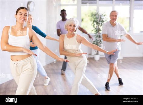 Female Instructor Teaches Mature Students Of Dance Class Basic Movements Of Hip Hop Dance Stock