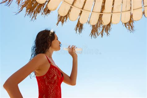 Beautiful Brunette Girl In Red Swimsuit Drinking Water On A Vacation Day Stock Image Image Of