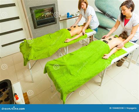 Massage With Hot Rocks Stones In Beautician Stock Photo Image Of Skin