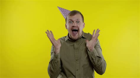 Shocked store client. Man showing Up To 70 Percent Off inscriptions