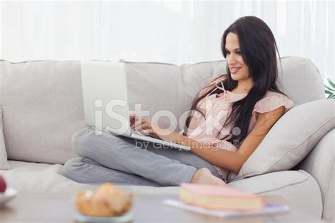 Attractive Brunette Using Her Laptop Stock Photo Royalty Free FreeImages