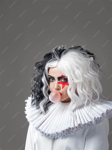 Funny shocking young woman in bright makeup and with a black and white