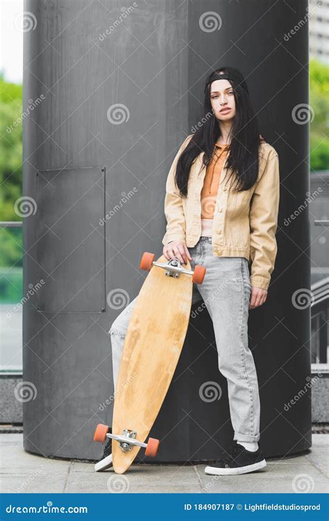 Calm Brunette Woman With Skateboard Standing On Rooftop Stock Image Image Of Casual City