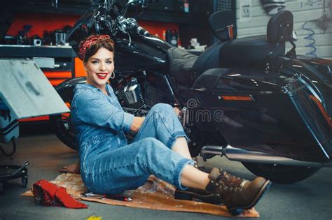 Beautiful Girl Repairs A Motorcycle In A Workshop Pin Up Style