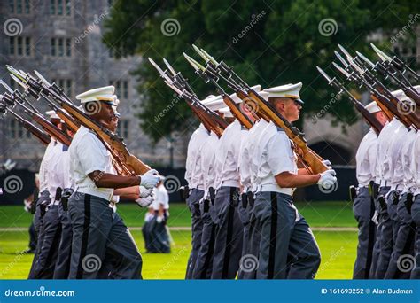 Groups Of Army Cadets In Formation Holding Rifles And Marching On The