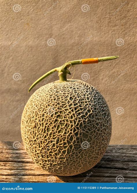 Fresh Japanese Melon On The Wooden Table And Cement Background Stock