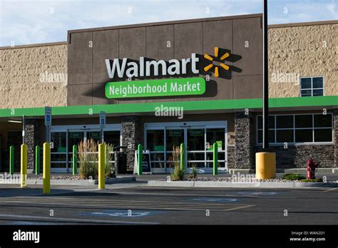 A Logo Sign Outside Of A Walmart Neighborhood Market Retail Store