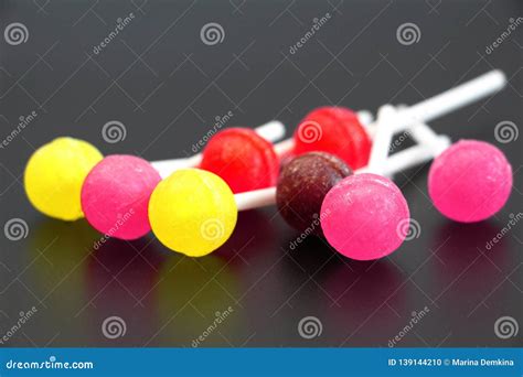 Sweet Multicolored Caramel On A Stick Sweets Laid Out On The Table