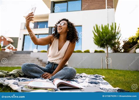 Young Afro Woman Taking Selfie While Sitting On Grass At Backyard Outdoors Stock Image Image