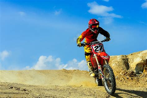 rider riding green motocross dirt bike  stock photo