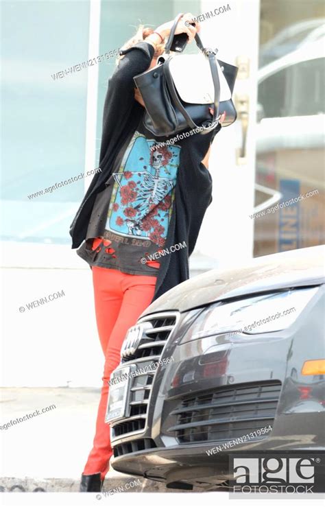 Vanessa Hudgens With Blonde Hair Keeps Hidden As She Covers Her Face With Her Handbag
