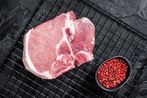 Premium Photo Uncooked Raw Pork T Bone Chop Meat Steak On Grill Black