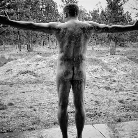 Premium Photo Rear View Of Naked Man With Arms Outstretched Enjoying Rain While Standing Outdoors